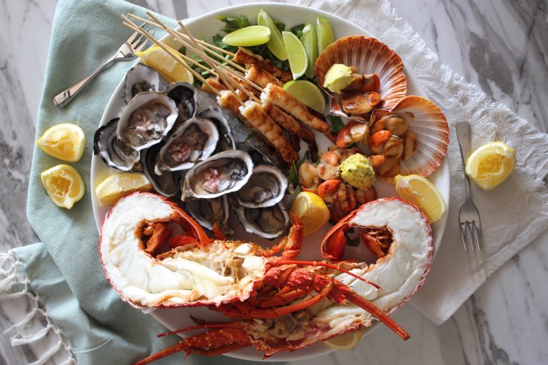 Seafood platter with fresh lobster, oysters, charred lime prawns and